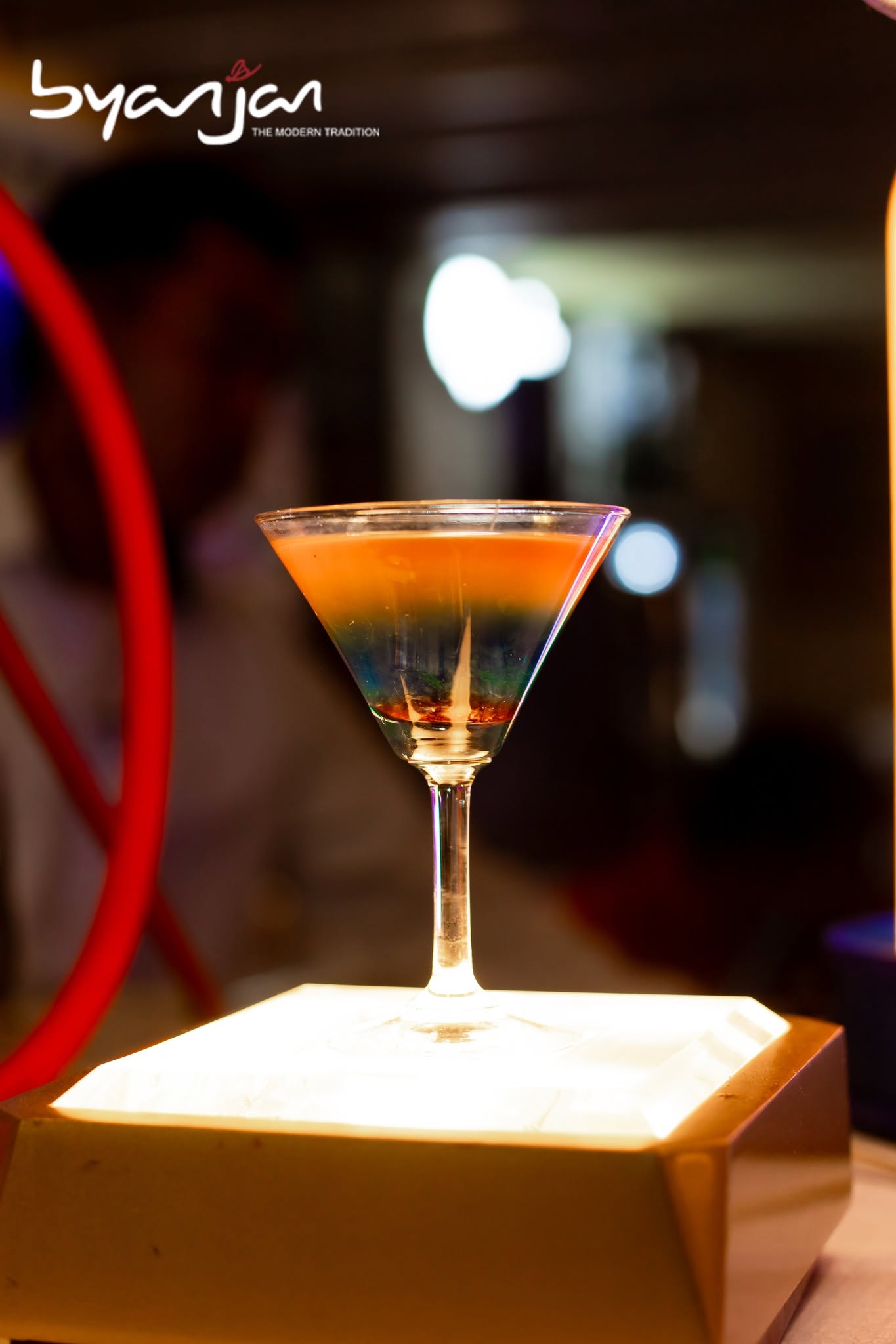 A stemmed cocktail in the warm light of the Byanjan bar