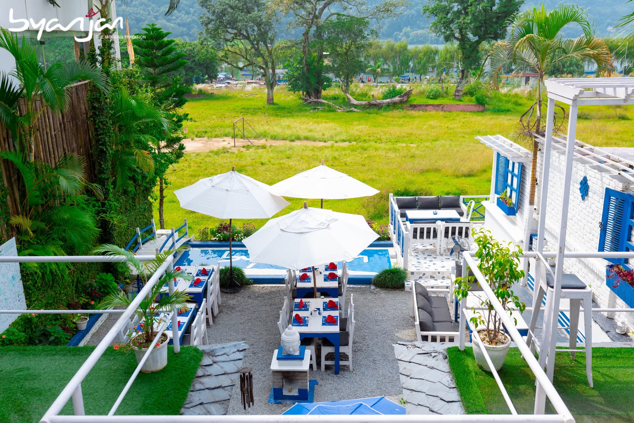 Blue-and-white garden tables beneath white parasols