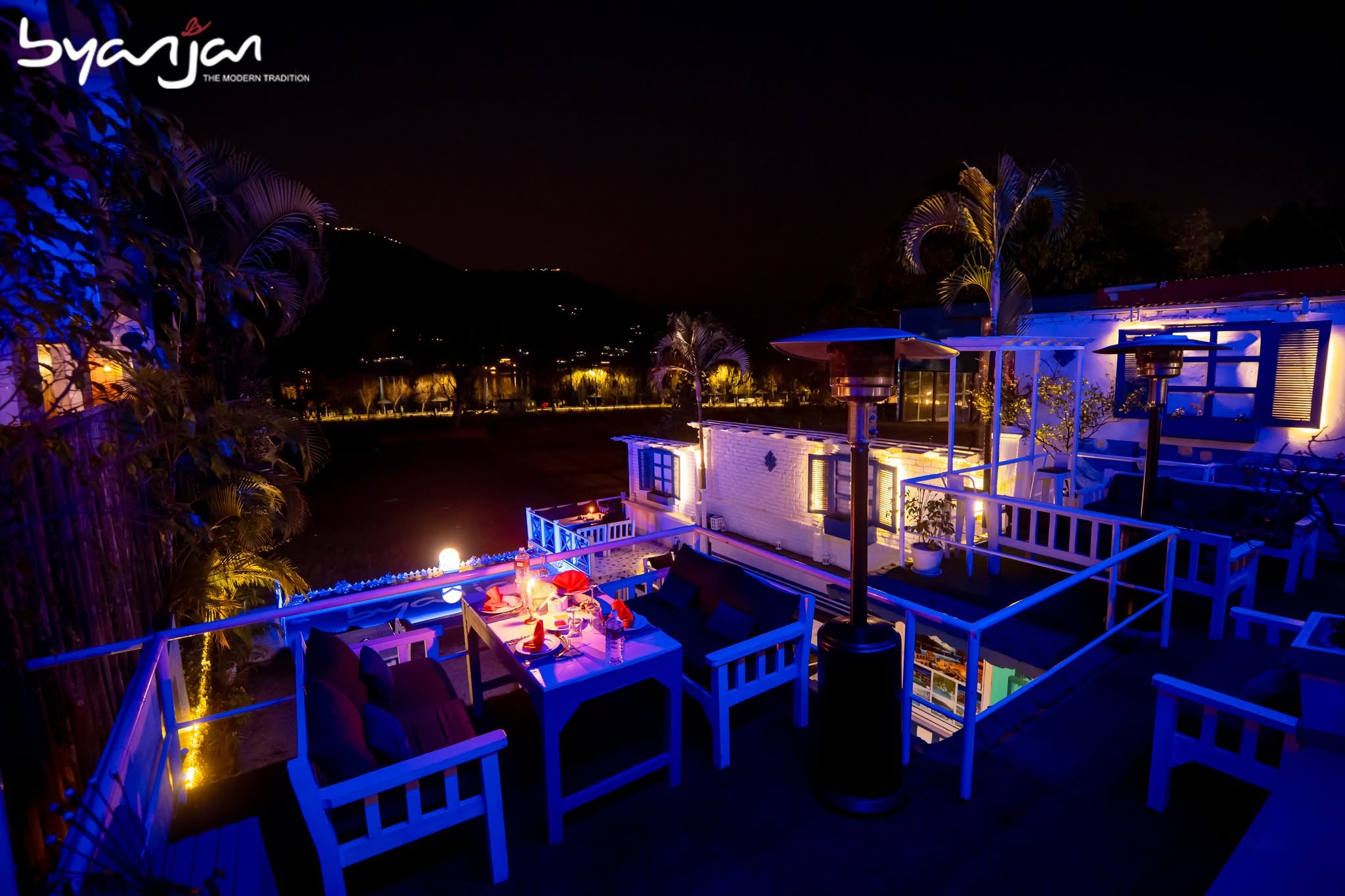 Blue-lit terrace tables at Byanjan after dark